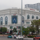 A Vingroup Vincom shopping plaza on the corner of two busy streets.